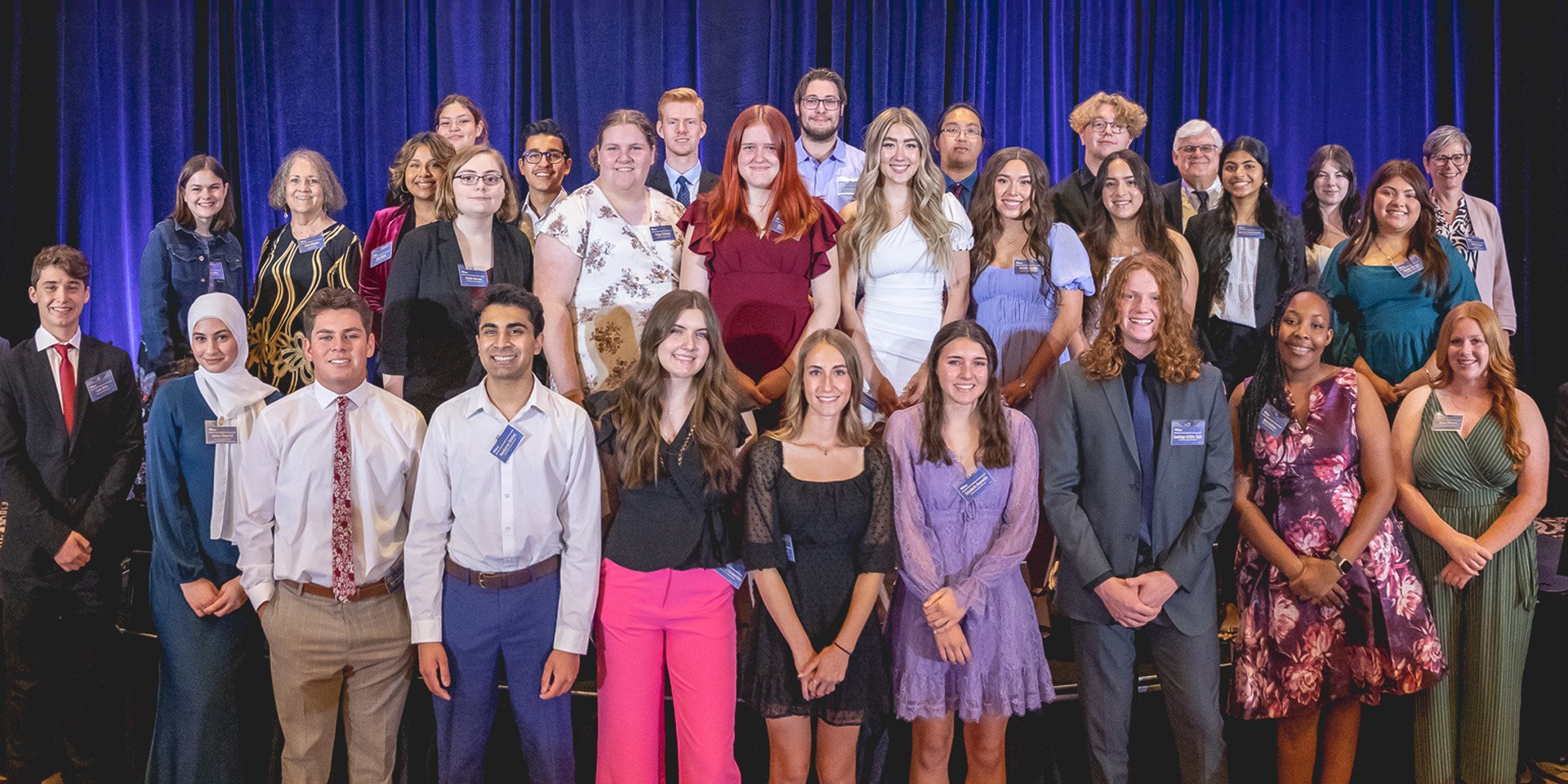 Jeff Meshey proudly stands alongside a group of 30 senior high school students who have been honored with the Community Service Scholarship.