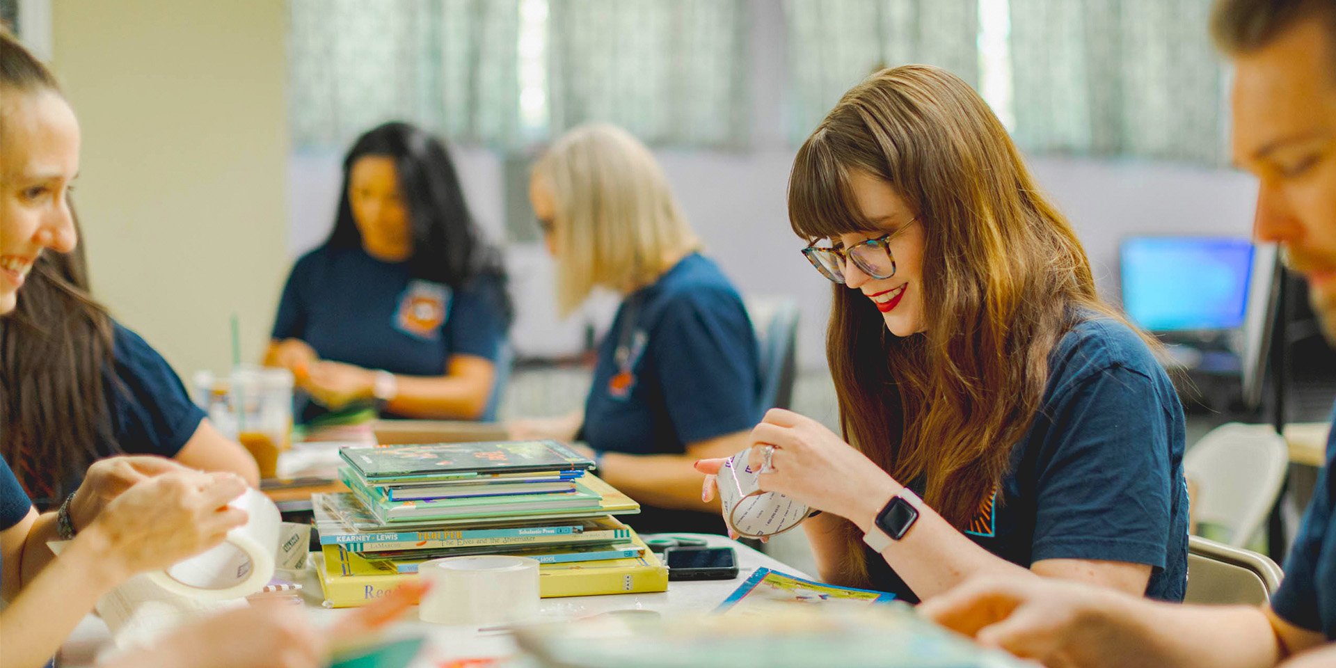 Desert Financial employees volunteer by repairing books.