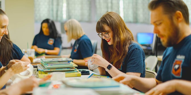 Desert Financial employees volunteer by repairing books.