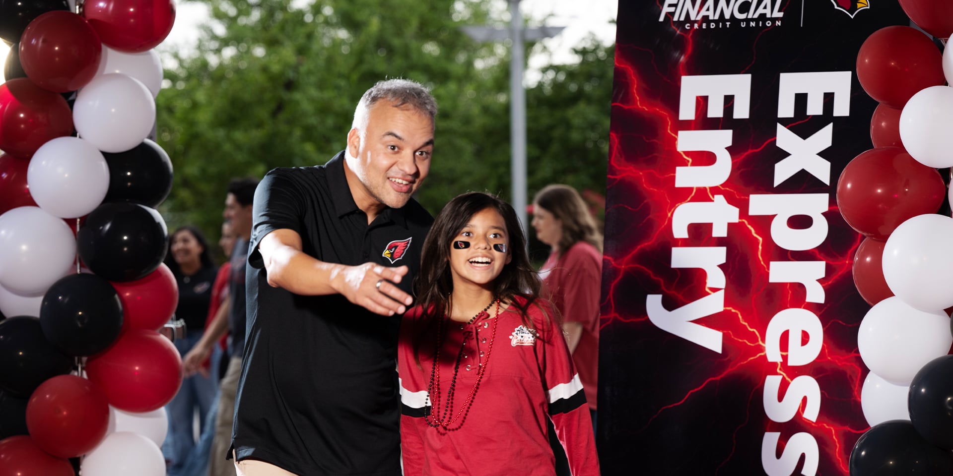 Two Cardinals fans and Desert Financial members going through the express stadium entry at State Farm Stadium
