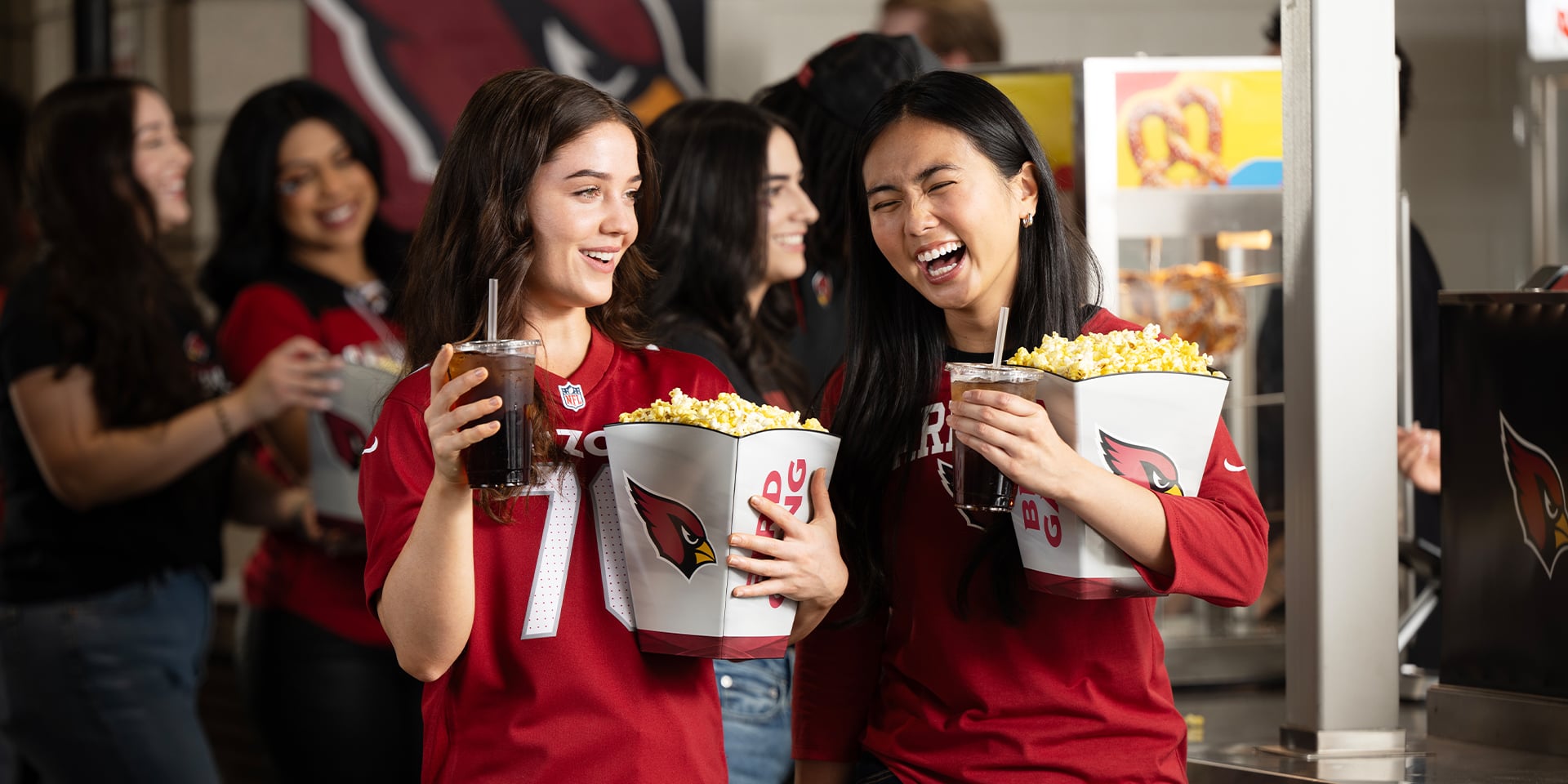 Two Cardinals fans eating stadium popcorn
