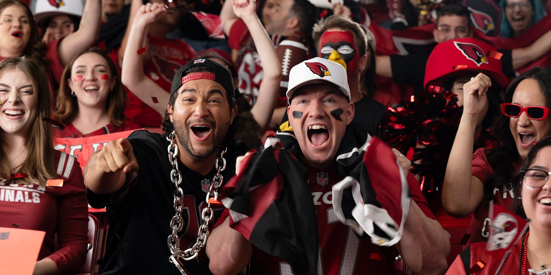 Cardinals fans cheering at the football game