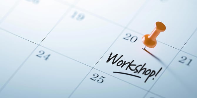 Zoomed-in picture of a calendar highlighting the 20th with an orange tack, featuring the word 'Workshop!' written across the square. Zoomed-in picture of a calendar highlighting the 20th with an orange tack, featuring the word 'Workshop!' written across the square.
