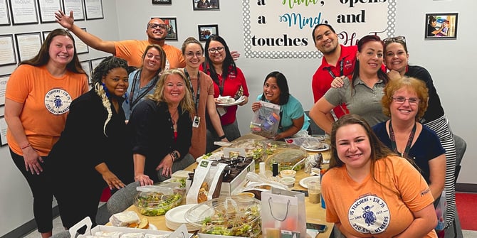 Desert Financial employees gifting teachers with lunch and goodies in the school's breakroom.